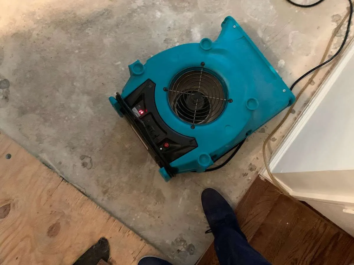 Air mover drying subfloor during Leak Detection & Repair in Hudson Falls